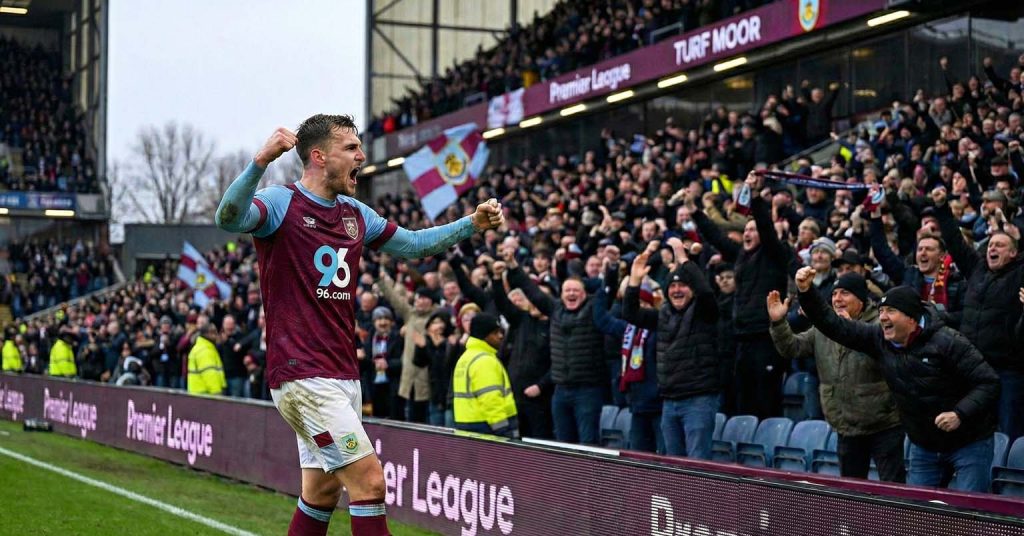 Burnley player celebrates with supporters.